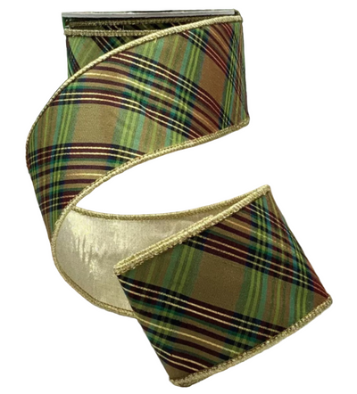 Plaid ribbon with gold edge on a wooden surface with Christmas tree background